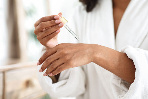Woman applying serum to her hands