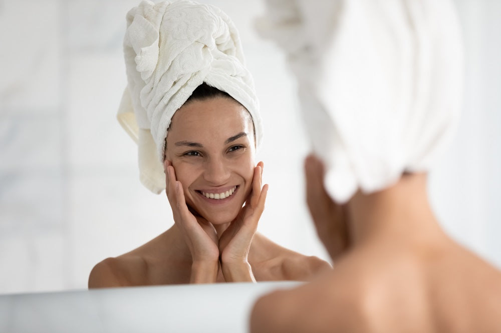 Woman putting moisturizing cream on her face